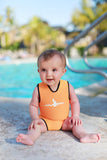 A baby is sitting in front of a pool wearing a Mango orange Infant Warm Belly Wetsuit.