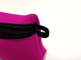 Close-up of pink Neoprene Beach Pouch showcasing the black finger loop for holding onto or attaching beach pouch to something. 